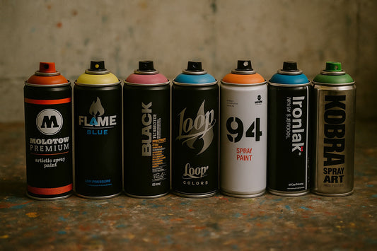 Photorealistic close-up of seven graffiti spray paint brands lined up on a messy worktable, showcasing the best spray paints for beginners